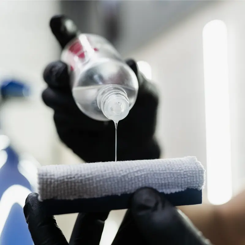 Ceramic coating being poured onto an applicator before application in Oakland