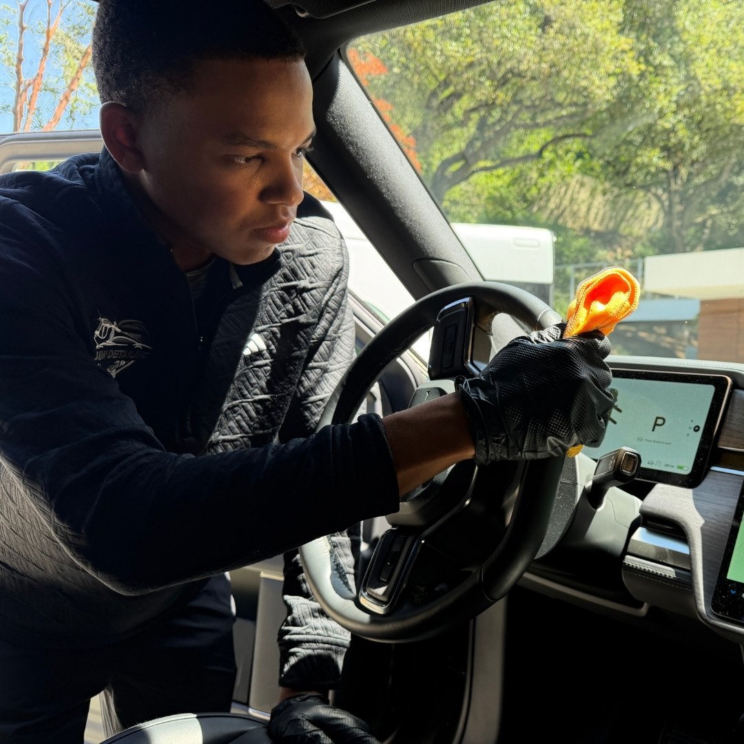 Jalil Wren, owner of J&W Mobile Detailing, detailing a steering wheel