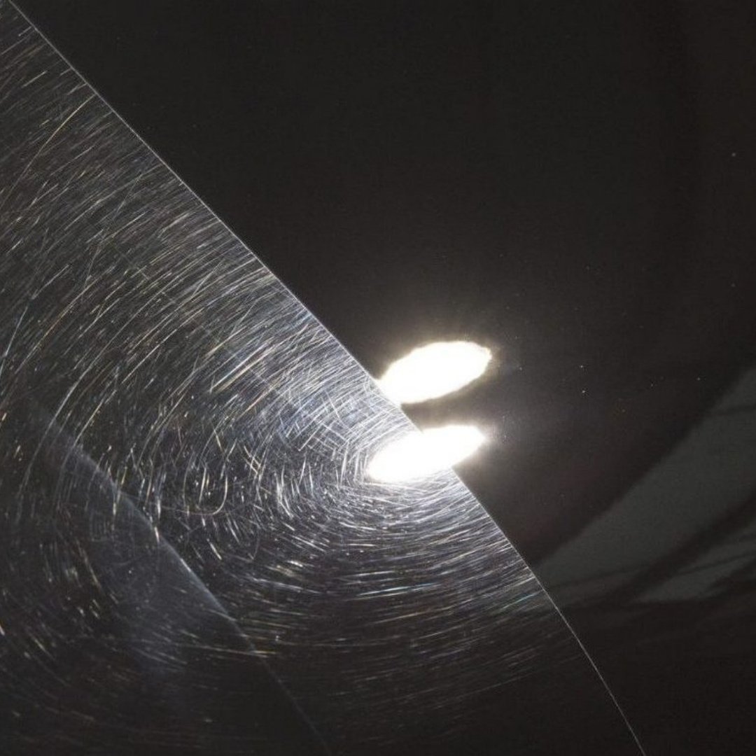 Swirl marks visible under inspection light before paint correction