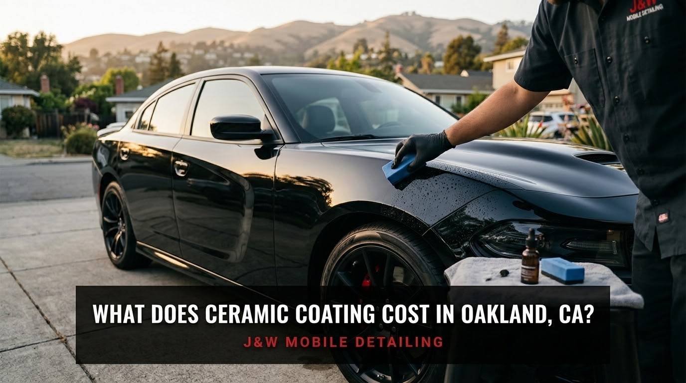 Black sedan freshly ceramic coated by J&W Mobile Detailing in an Oakland driveway